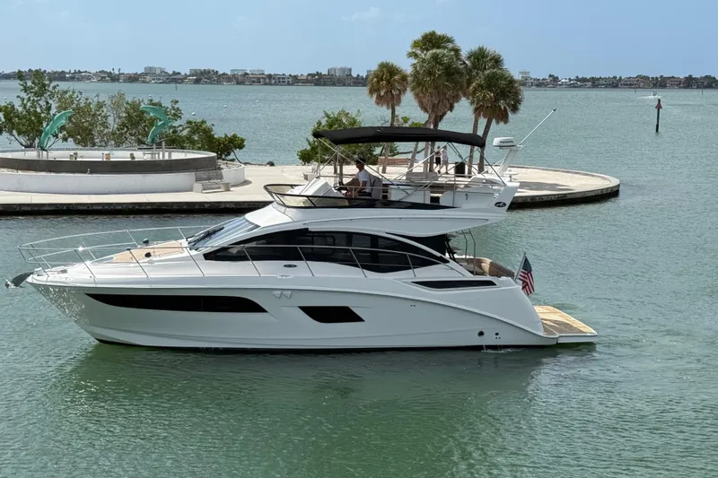 Tea Time III Yacht Photos Pics 2018 Sea Ray Fly 400 yacht cruising in a scenic coastal area with palm trees.