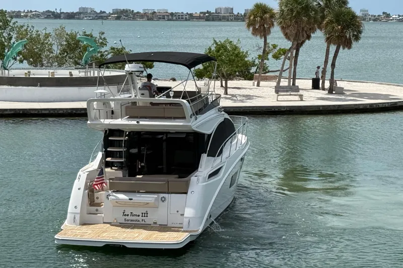 Tea Time III Yacht Photos Pics 2018 Sea Ray Fly 400 yacht cruising near a scenic waterfront with palm trees.