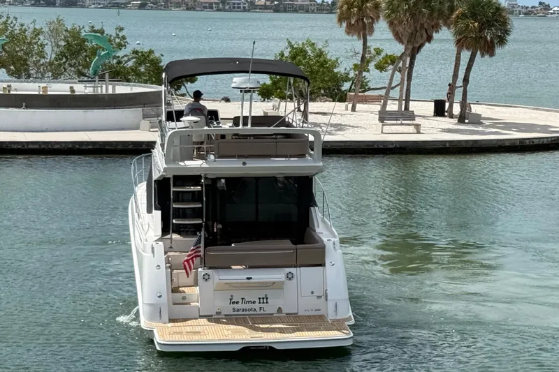 Tea Time III Yacht Photos Pics 2018 Sea Ray Fly 400 yacht cruising near Sarasota waterfront with palm trees.