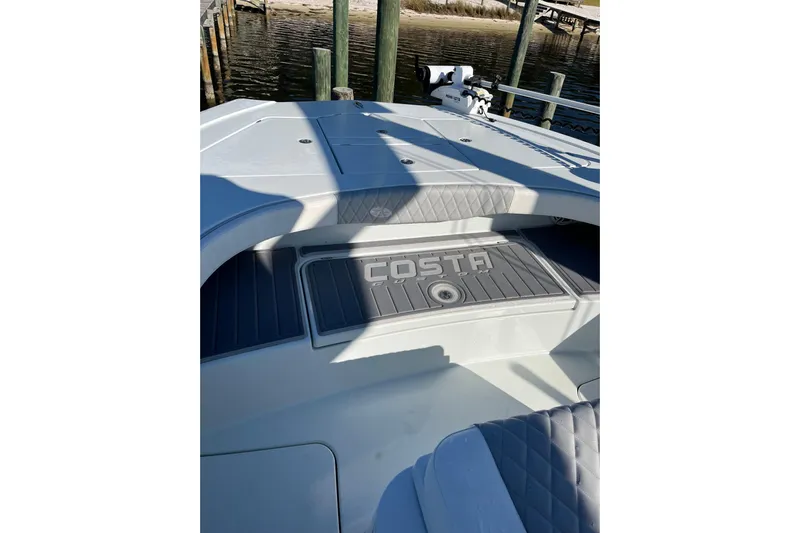  Yacht Photos Pics 2022 Costa Custom Boats 264 deck with logo, featuring sleek design and comfortable seating.