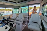 Interior of 2024 Saxdor 320 GTC boat with modern seating and scenic marina view.