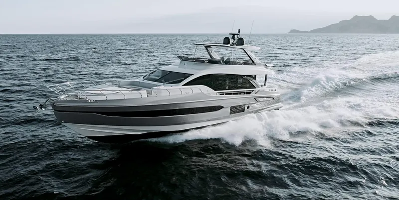  Yacht Photos Pics 2025 Azimut 78 Flybridge yacht cruising on open sea with mountainous backdrop.