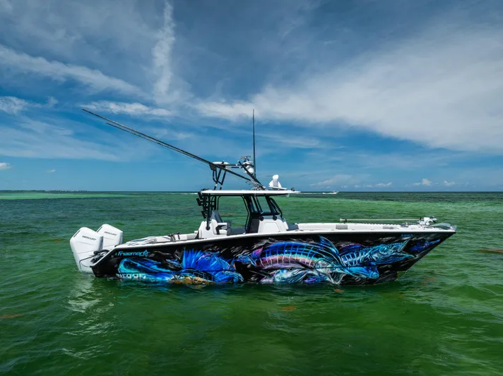 Yacht Photos Pics 2025 Freeman 34 VH boat with vibrant marine graphics on calm green water.