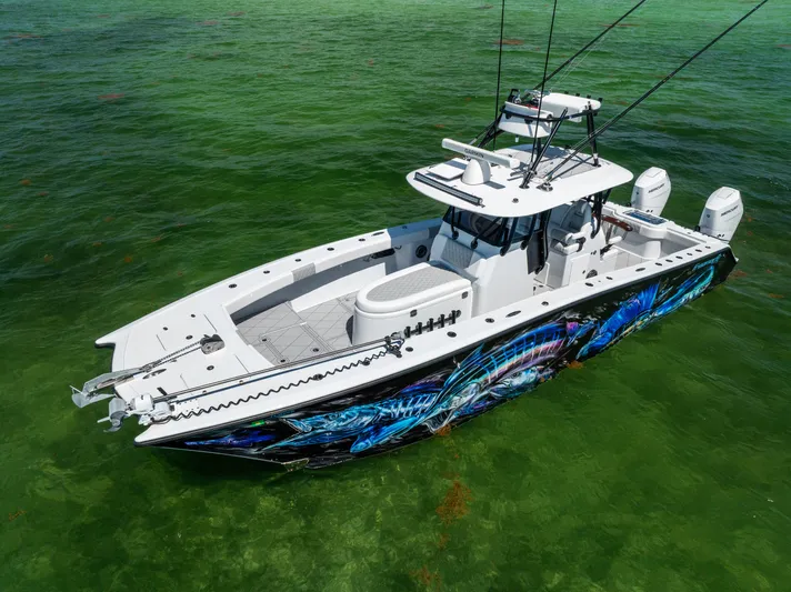  Yacht Photos Pics 2025 Freeman 34 VH boat with vibrant hull design on clear green water.