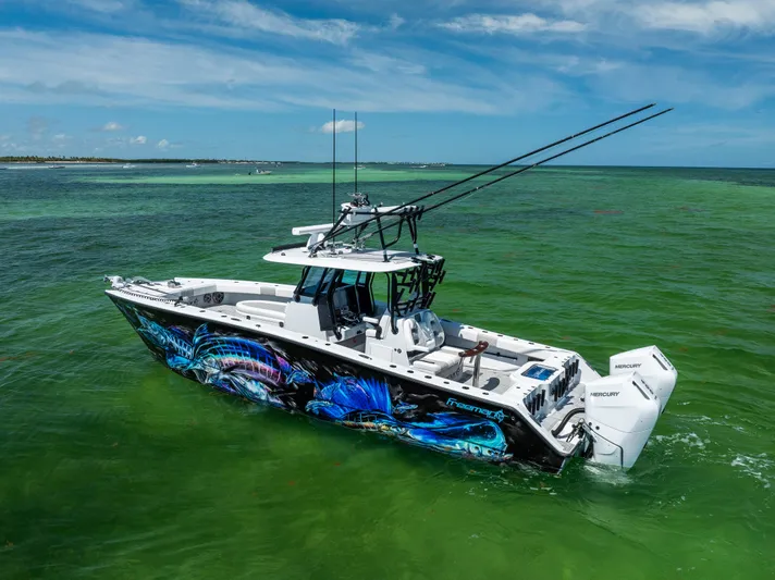  Yacht Photos Pics 2025 Freeman 34 VH boat with vibrant marine graphics on clear green water.