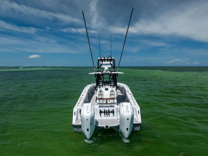 Yacht Photos Pics 2025 Freeman 34 VH boat on vibrant green ocean under blue sky.