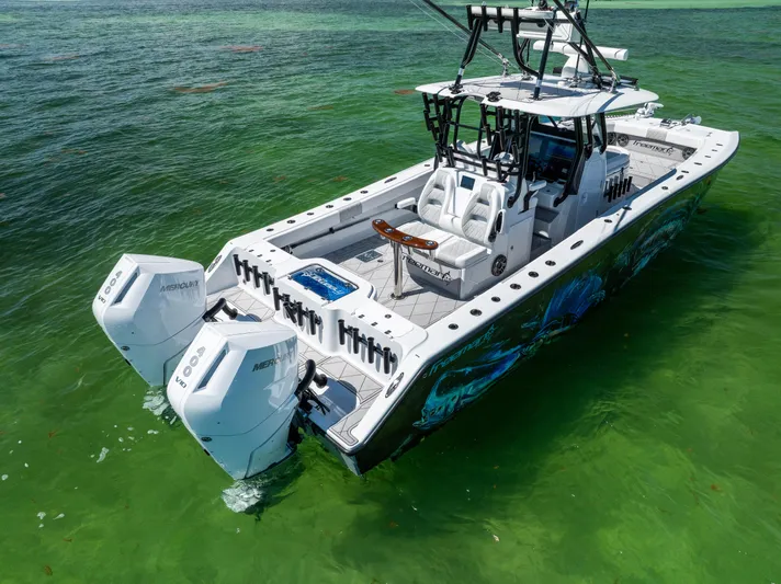  Yacht Photos Pics 2025 Freeman 34 VH boat with dual Mercury engines on clear green water.