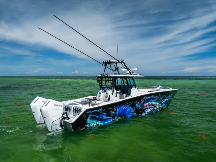  Yacht Photos Pics Freeman 34 VH 2025 boat with vibrant graphics on green ocean water.