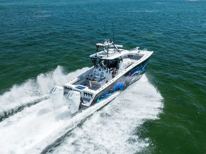  Yacht Photos Pics 2025 Freeman 34 VH boat cruising on open water with vibrant hull design.