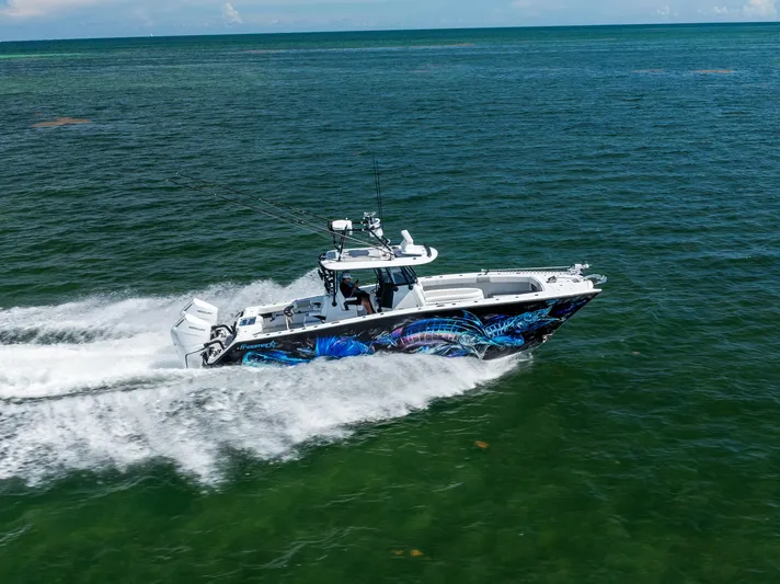  Yacht Photos Pics 2025 Freeman 34 VH boat cruising on open water with vibrant hull design.