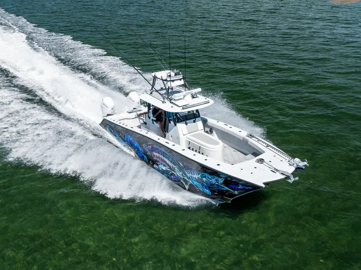  Yacht Photos Pics 2025 Freeman 34 VH boat cruising on open water with vibrant hull design.