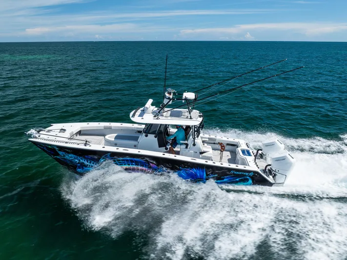  Yacht Photos Pics 2025 Freeman 34 VH boat cruising on open ocean with vibrant graphics and dual engines.