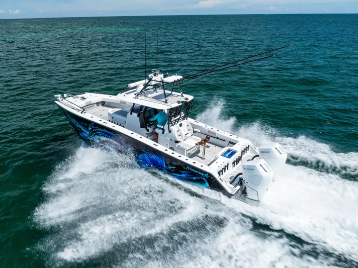  Yacht Photos Pics 2025 Freeman 34 VH boat cruising on open ocean with vibrant hull design.