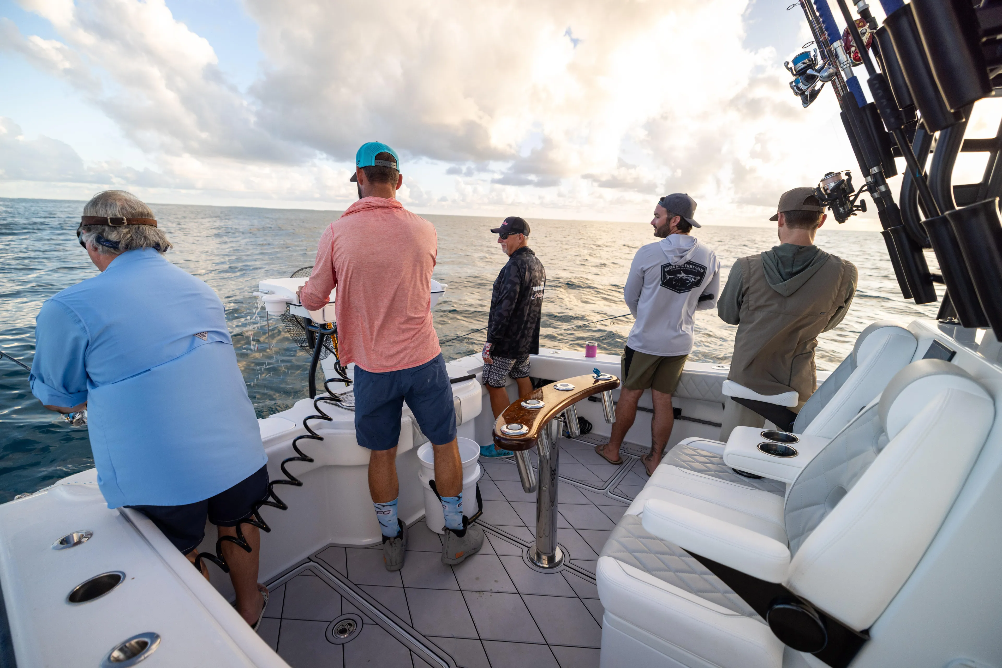  Yacht Photos Pics Group fishing on a Freeman 34 VH boat, 2025 model, under a cloudy sky.