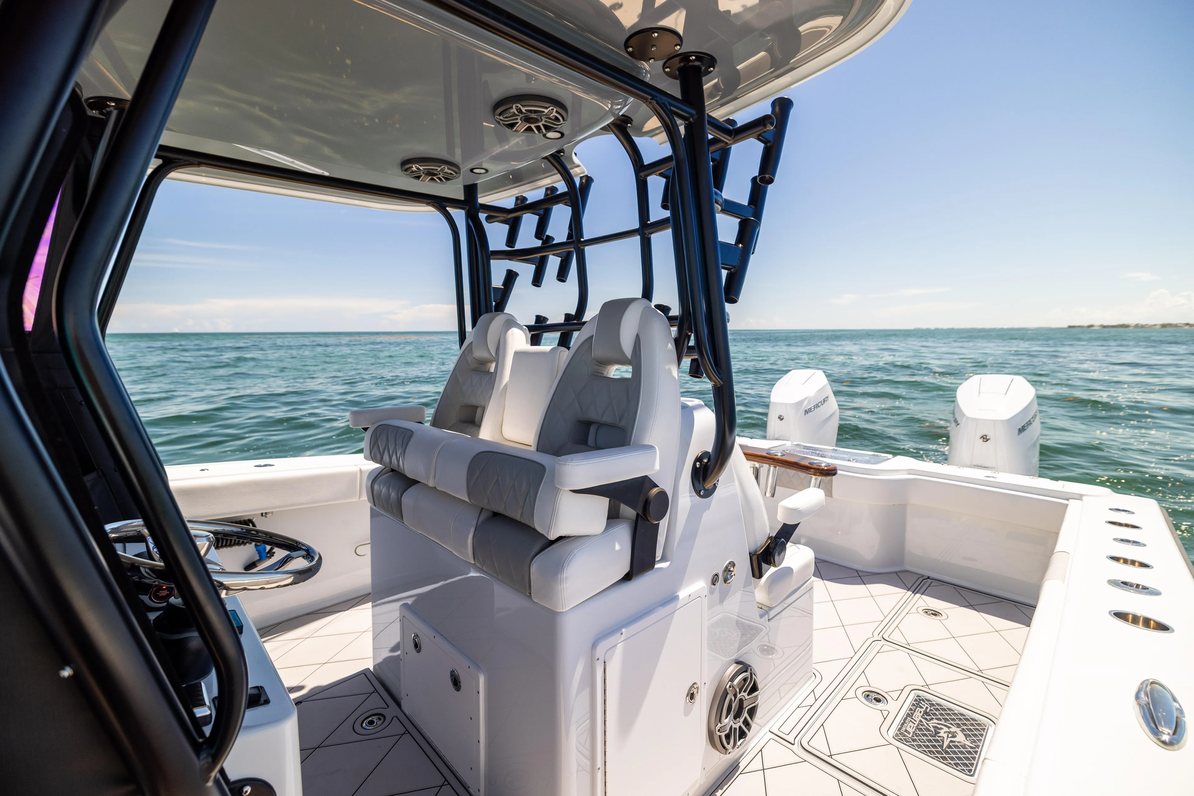  Yacht Photos Pics Freeman 34 VH 2025 boat interior with ocean view, featuring modern seating and controls.