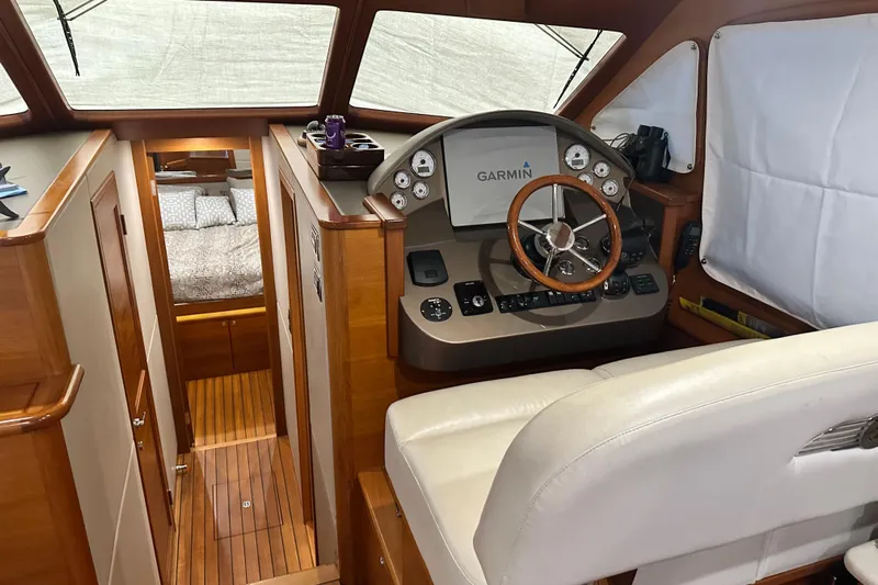 “no Name” Yacht Photos Pics 2017 Palm Beach PB42 yacht interior with helm, Garmin display, and cozy cabin view.