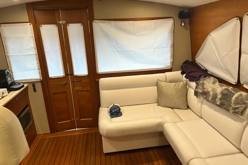 “no Name” Yacht Photos Pics Interior of 2017 Palm Beach PB42 yacht with white seating and wooden flooring.