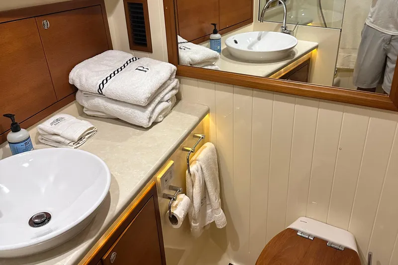 “no Name” Yacht Photos Pics Luxurious bathroom in 2017 Palm Beach PB42 yacht with elegant fixtures and plush towels.