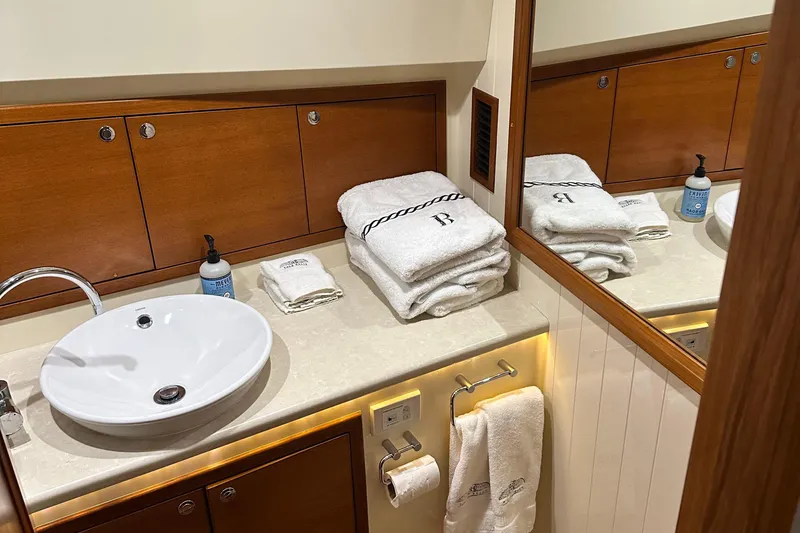 “no Name” Yacht Photos Pics Luxurious bathroom in 2017 Palm Beach PB42 yacht with elegant wood cabinetry and plush towels.
