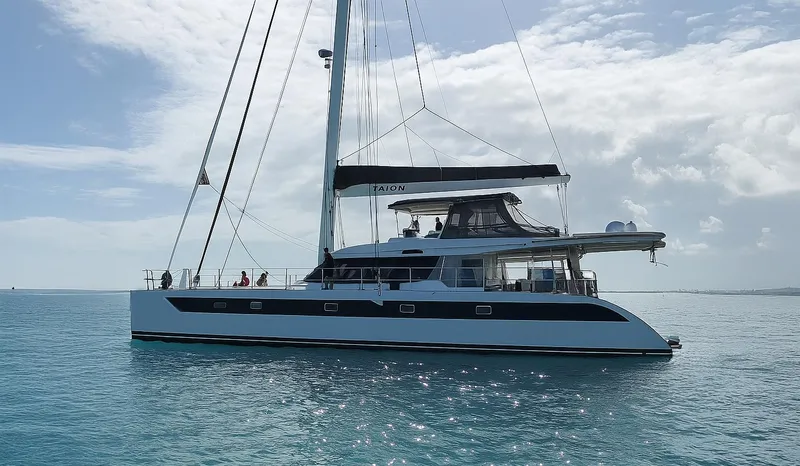 Talon Yacht Photos Pics 2011 Sunreef 62 catamaran sailing on calm blue waters under a partly cloudy sky.