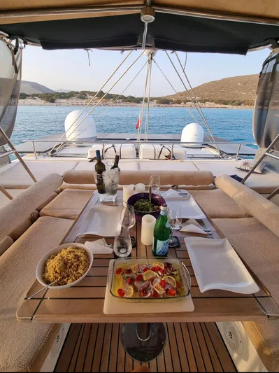 Talon Yacht Photos Pics Luxurious dining setup on a 2011 Sunreef 62 yacht, overlooking serene blue waters.