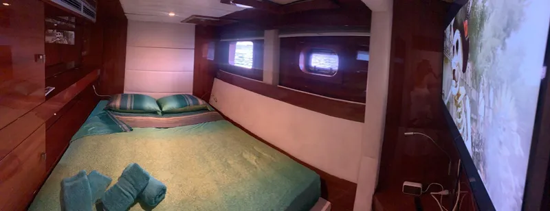 Talon Yacht Photos Pics Luxurious Sunreef 62 yacht bedroom interior with elegant wood finish and ocean view windows.