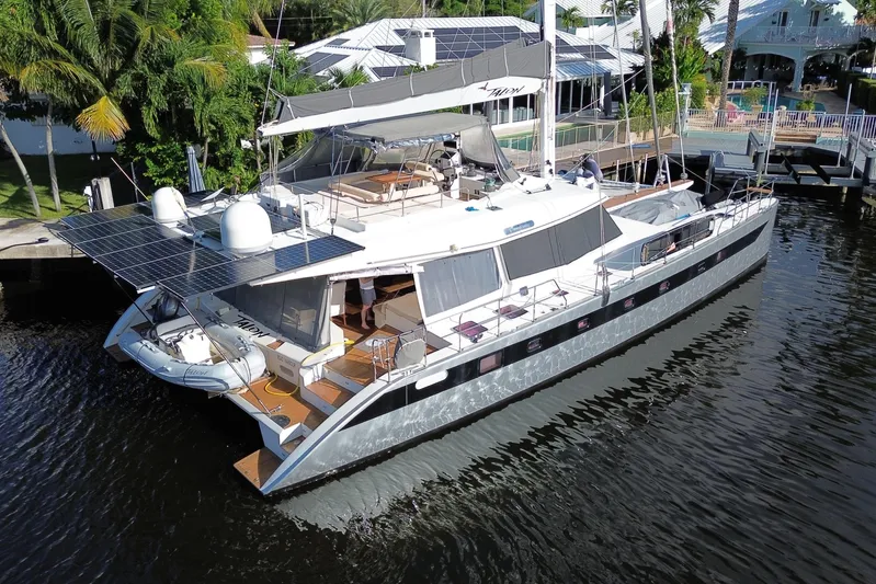 Talon Yacht Photos Pics Luxurious 2011 Sunreef 62 yacht docked, featuring solar panels and spacious deck.