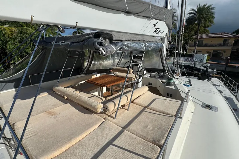 Talon Yacht Photos Pics Luxurious 2011 Sunreef 62 yacht deck with cushioned seating and wooden table.
