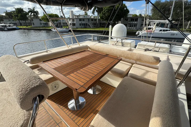 Talon Yacht Photos Pics Luxurious Sunreef 62 yacht deck with cushioned seating and wooden table, 2011 model.