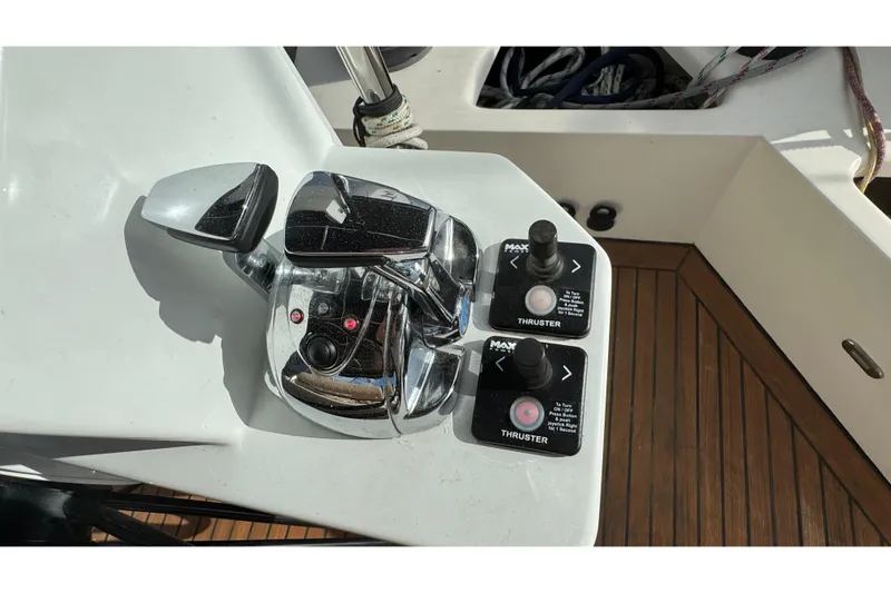 Talon Yacht Photos Pics Control panel of a 2011 Sunreef 62 yacht with thruster controls and chrome levers.