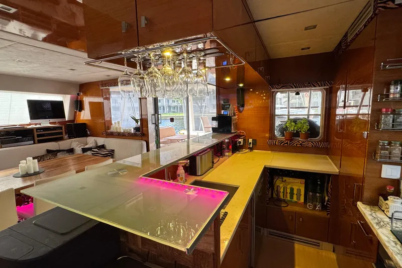 Talon Yacht Photos Pics Luxurious interior of a 2011 Sunreef 62 yacht with modern kitchen and lounge area.