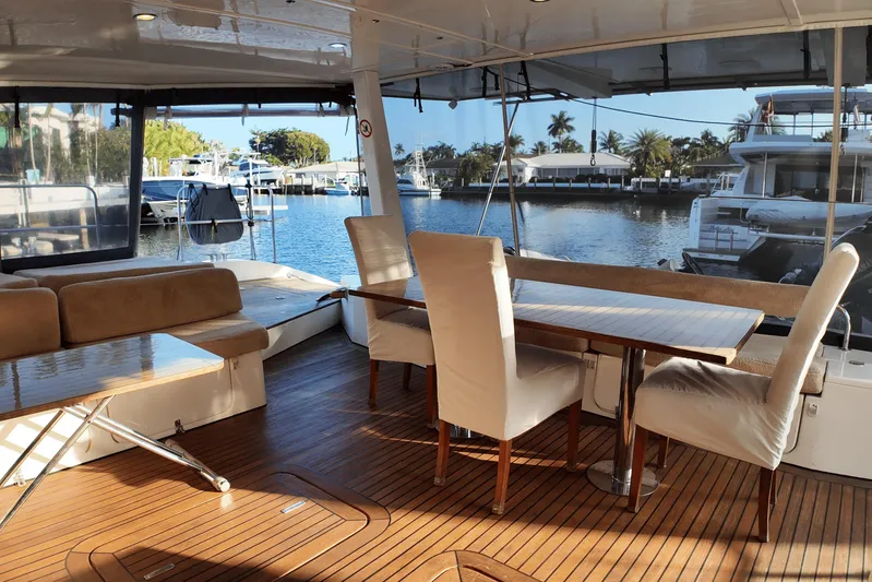 Talon Yacht Photos Pics Luxurious Sunreef 62 yacht interior with elegant seating, wooden flooring, and marina view, 2011 model.