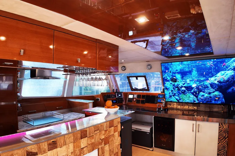 Talon Yacht Photos Pics Luxurious interior of 2011 Sunreef 62 yacht with modern kitchen and large aquarium display.