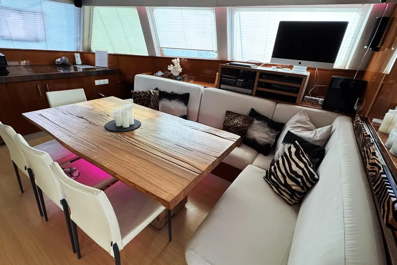 Talon Yacht Photos Pics Luxurious interior of 2011 Sunreef 62 yacht with modern dining area and stylish decor.
