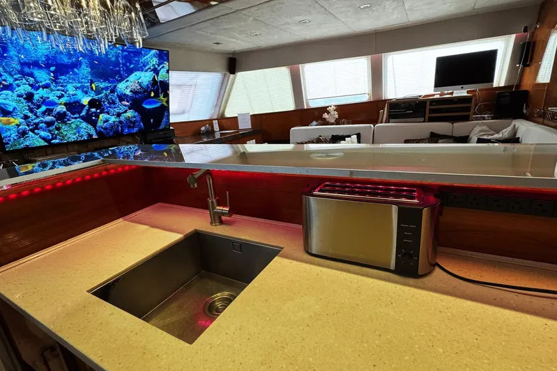 Talon Yacht Photos Pics Luxurious Sunreef 62 yacht interior with modern kitchen, featuring a sink and toaster, 2011 model.