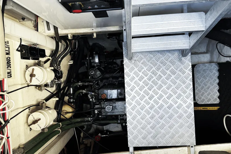 Talon Yacht Photos Pics Engine room of a 2011 Sunreef 62 yacht, featuring mechanical components and metal flooring.