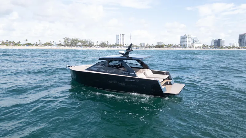  Yacht Photos Pics 2024 Colnago C38 OPEN yacht cruising near a coastal city skyline.