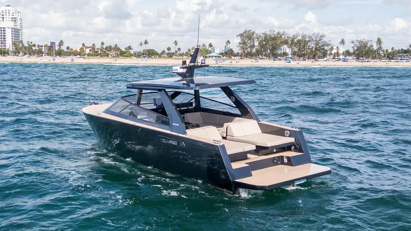  Yacht Photos Pics 2024 Colnago C38 OPEN yacht cruising near a sandy beach under a partly cloudy sky.