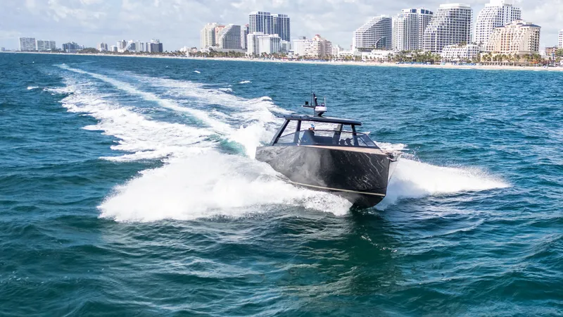  Yacht Photos Pics 2024 Colnago C38 OPEN boat cruising near city skyline on blue ocean waters.