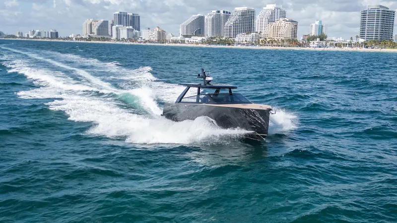  Yacht Photos Pics 2024 Colnago C38 OPEN yacht cruising near a city skyline on a sunny day.