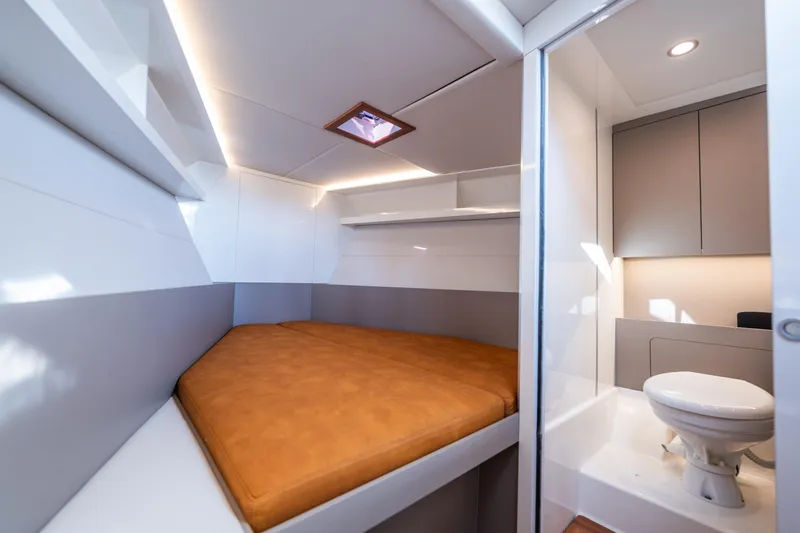  Yacht Photos Pics Modern interior of 2024 Colnago C38 OPEN yacht with cozy bed and compact bathroom.
