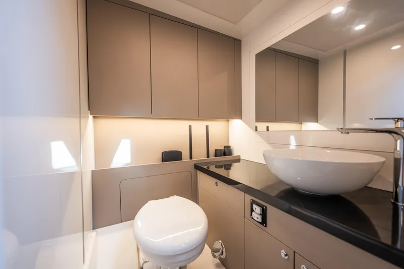  Yacht Photos Pics Modern bathroom with sleek fixtures, vessel sink, and ambient lighting.
