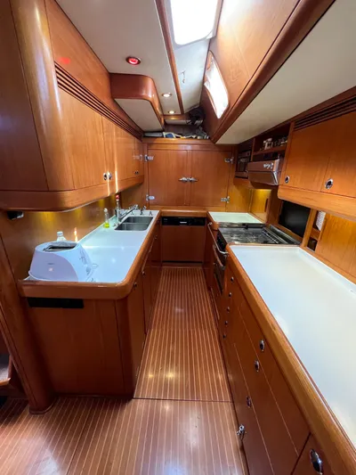  Yacht Photos Pics Spacious galley in a 1999 Nautor Swan 68 yacht with wooden cabinetry and modern appliances.