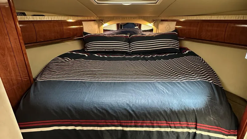  Yacht Photos Pics Luxurious cabin interior of 2006 Sea Ray 44 Sundancer yacht with striped bedding.