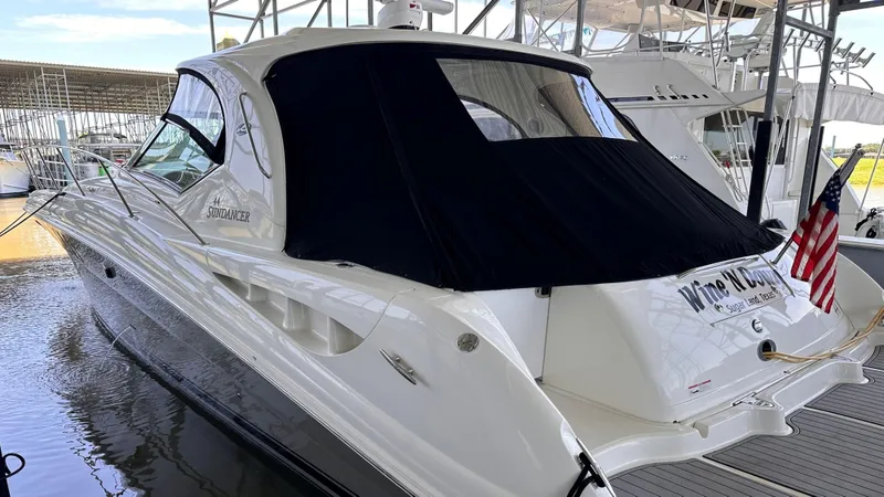  Yacht Photos Pics 2006 Sea Ray 44 Sundancer yacht docked, featuring sleek design and covered cockpit.