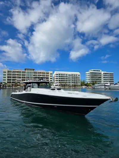 Lady Mash Yacht Photos Pics 2021 HCB 65 Estrella yacht in marina with modern buildings and blue sky.