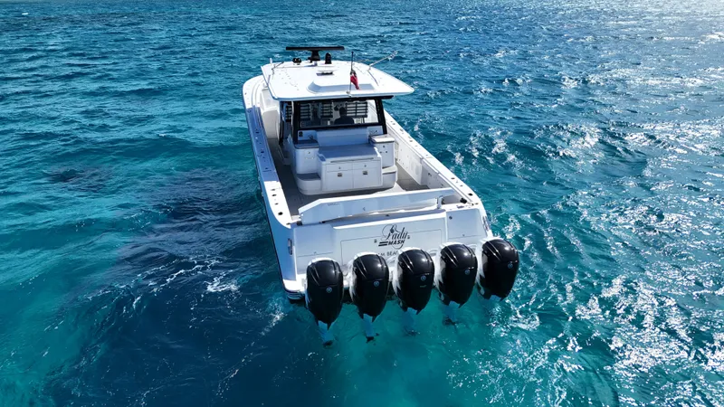 Lady Mash Yacht Photos Pics 2021 HCB 65 Estrella boat with five engines on clear blue ocean water.