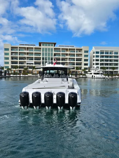 Lady Mash Yacht Photos Pics 2021 HCB 65 Estrella boat with six engines in a marina, modern buildings in background.