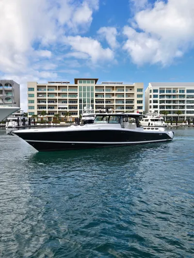 Lady Mash Yacht Photos Pics 2021 HCB 65 Estrella yacht docked in marina, modern buildings in background.