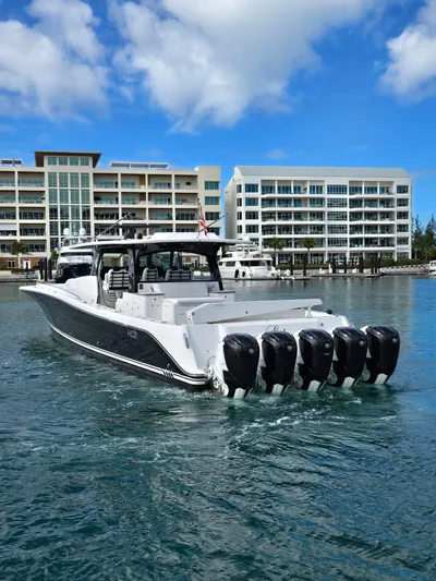 Lady Mash Yacht Photos Pics 2021 HCB 65 Estrella boat with multiple engines docked near modern buildings.